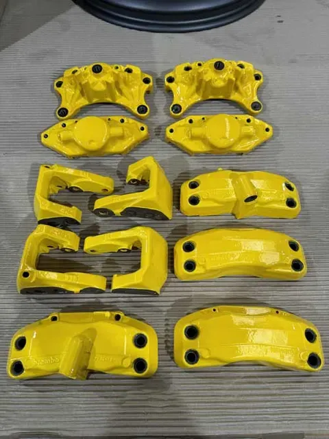 Yellow calipers and brackets laid out together