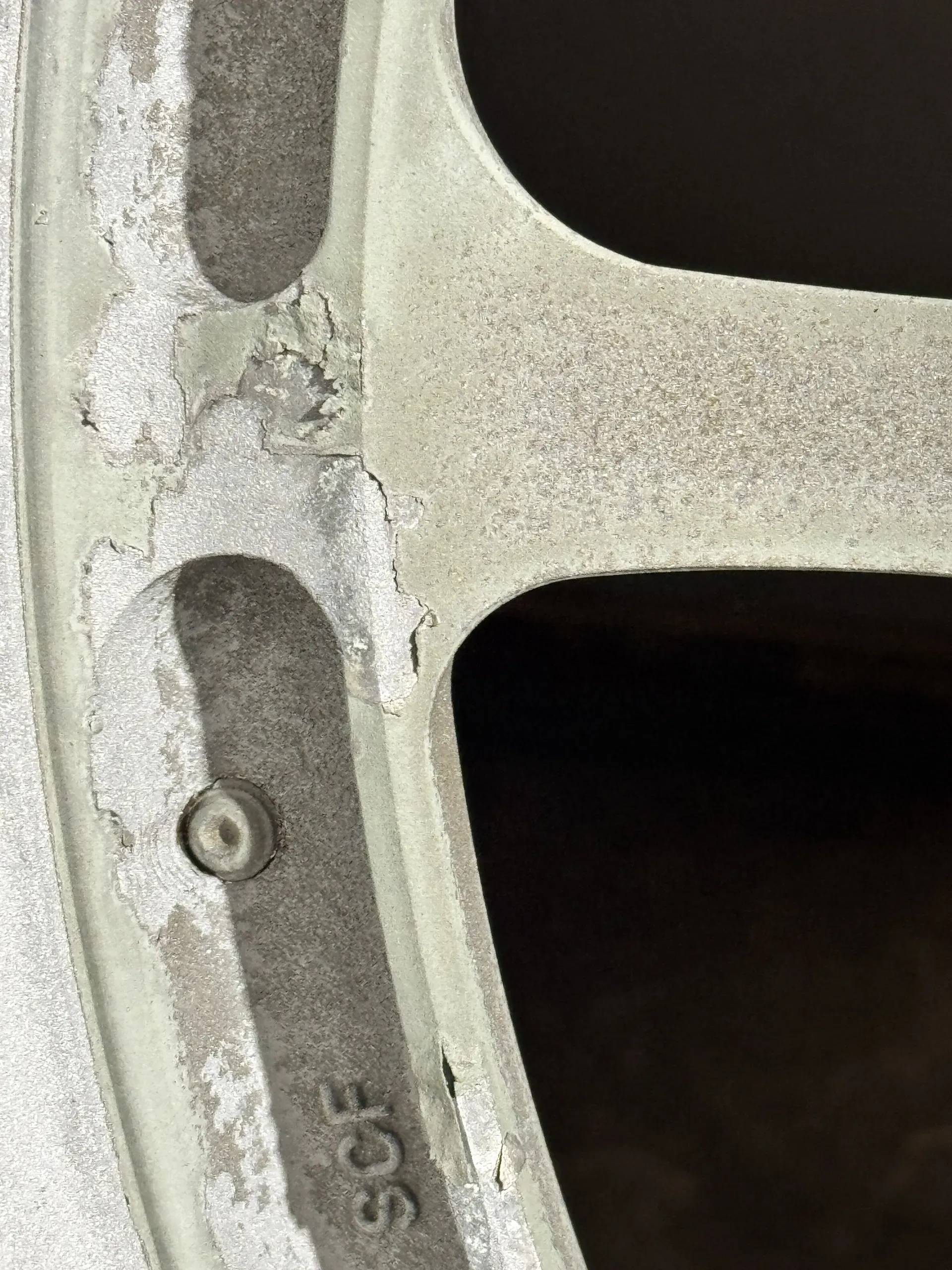 Paint lifting and flaking on a wheel face as it arrived